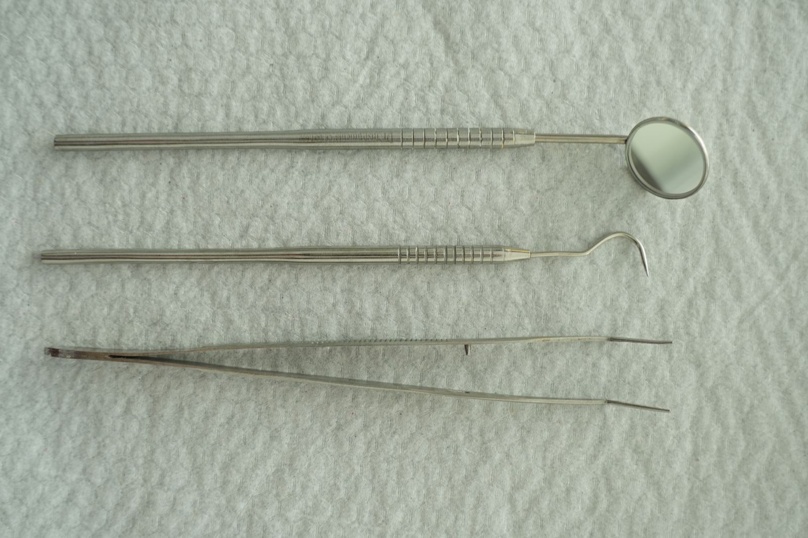 Dental examination instruments on a white cloth